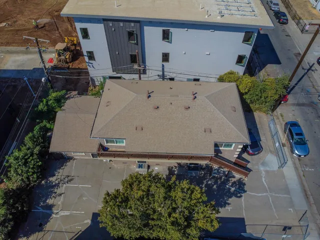 an aerial view of a house with a yard