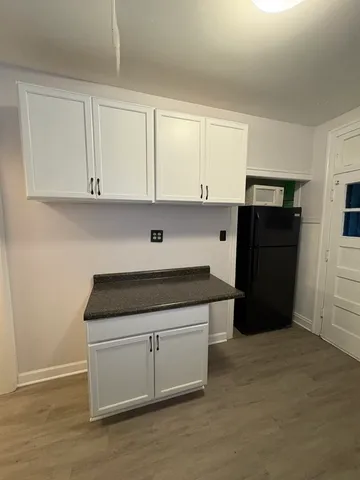 a kitchen with a refrigerator and cabinets