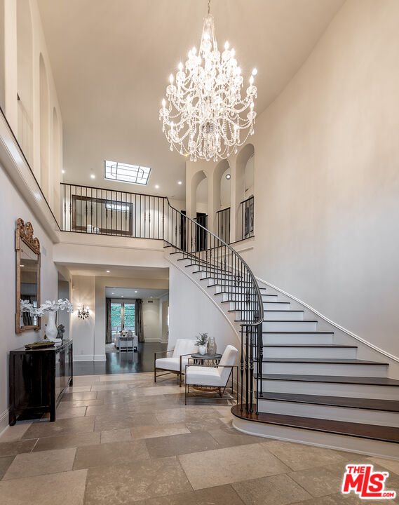 706 North Crescent Drive Beverly Hills, CA 90210 - Photo 11 of 34 a view of entryway with a chandelier and living room