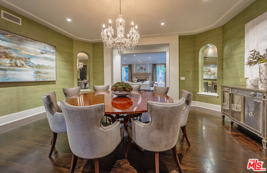 706 North Crescent Drive Beverly Hills, CA 90210 - Photo 19 of 34 a view of a dining room with furniture a chandelier and wooden floor