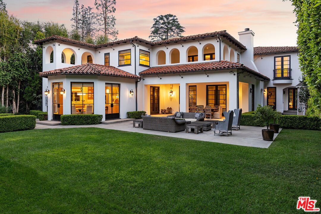706 North Crescent Drive Beverly Hills, CA 90210 - Photo 2 of 34 a front view of a house with patio and yard