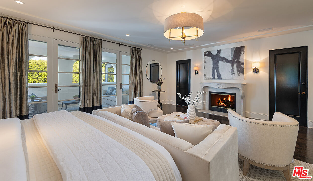 706 North Crescent Drive Beverly Hills, CA 90210 - Photo 21 of 34 a bedroom with a bed and a chandelier