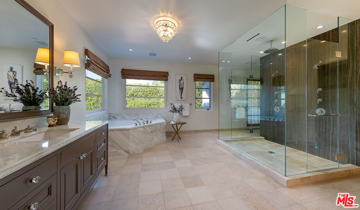 706 North Crescent Drive Beverly Hills, CA 90210 - Photo 24 of 34 a spacious bathroom with a granite countertop sink a mirror a bathtub and next to a window