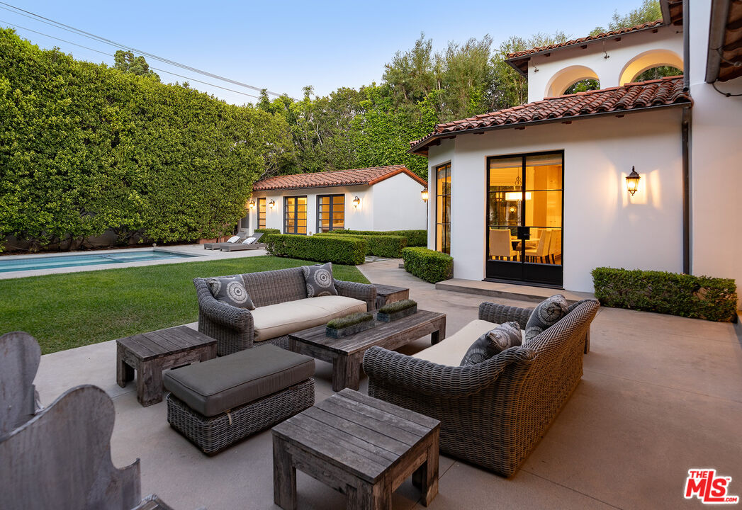 706 North Crescent Drive Beverly Hills, CA 90210 - Photo 3 of 34 a view of a house with couches chairs and a yard