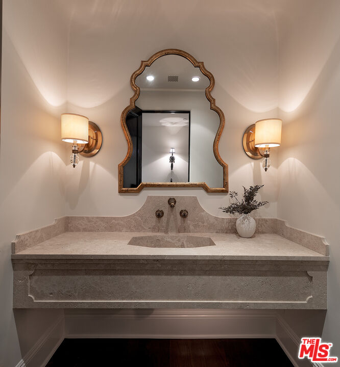 706 North Crescent Drive Beverly Hills, CA 90210 - Photo 33 of 34 a bathroom with a sink and a mirror
