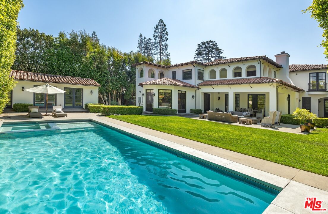 706 North Crescent Drive Beverly Hills, CA 90210 - Photo 6 of 34 a front view of a house with a yard table and chairs