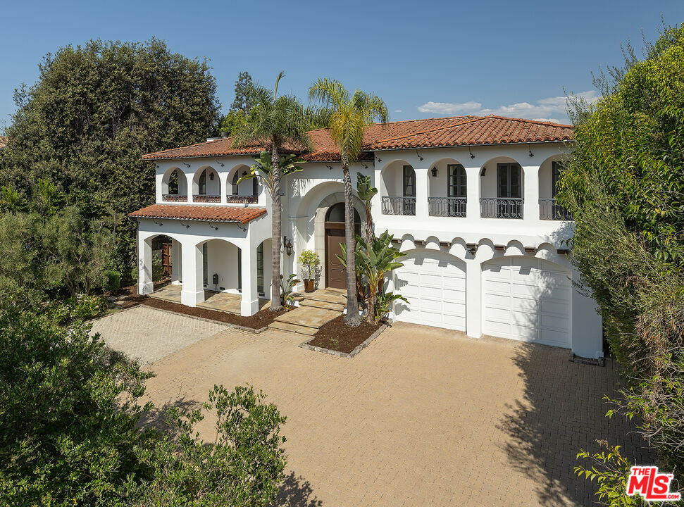 706 North Crescent Drive Beverly Hills, CA 90210 - Photo 9 of 34 a front view of a house with garden