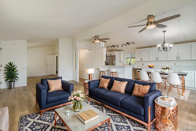 a living room with furniture and kitchen view