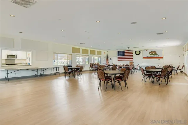 a room with pool table and windows
