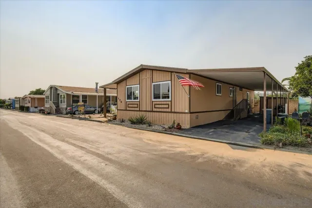 a view of a house with a wooden fence