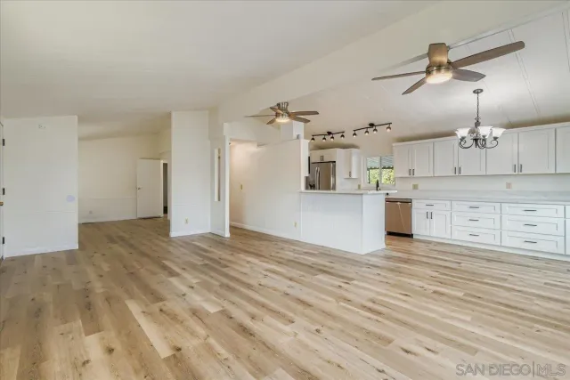 a view of a kitchen with a sink and cabinets