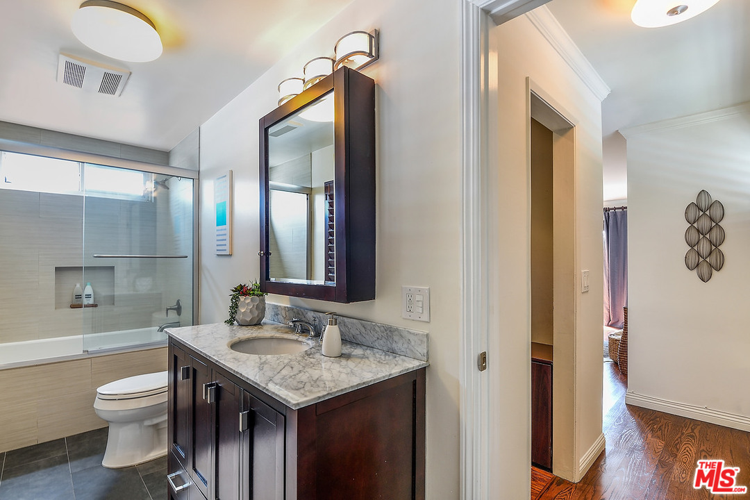 1102 Grant Avenue Venice, CA 90291 - Photo 16 of 29 a bathroom with a granite countertop sink toilet and shower