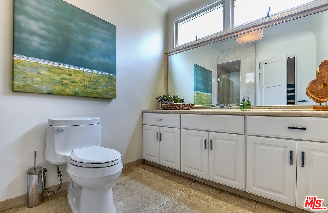 1102 Grant Avenue Venice, CA 90291 - Photo 18 of 29 a bathroom with a toilet sink and mirror