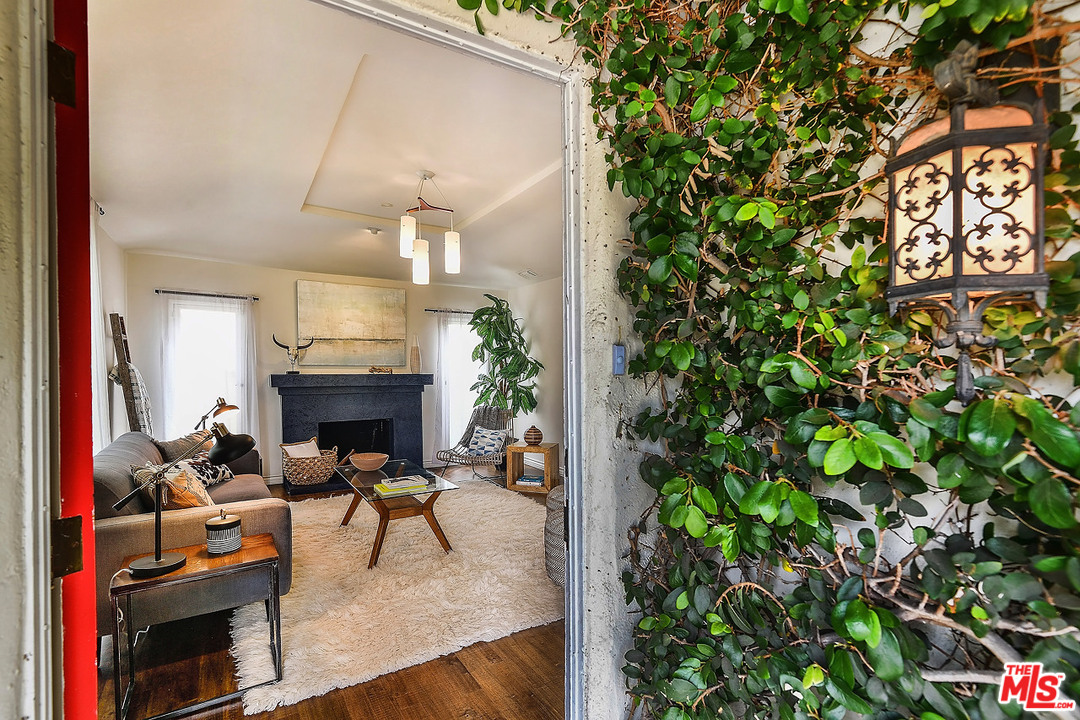 1102 Grant Avenue Venice, CA 90291 - Photo 3 of 29 a living room with furniture a fireplace and a potted plant