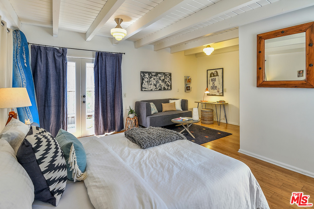 1102 Grant Avenue Venice, CA 90291 - Photo 23 of 29 a bedroom with a bed and a lamp with mirror