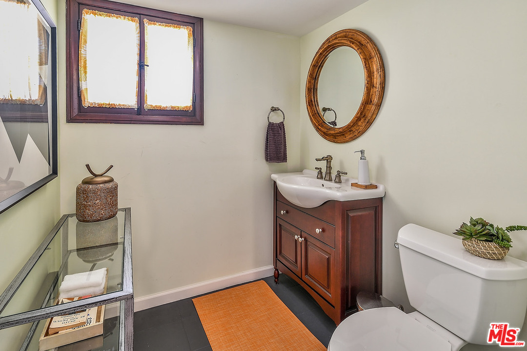 1102 Grant Avenue Venice, CA 90291 - Photo 25 of 29 a bathroom with a toilet a sink and a mirror
