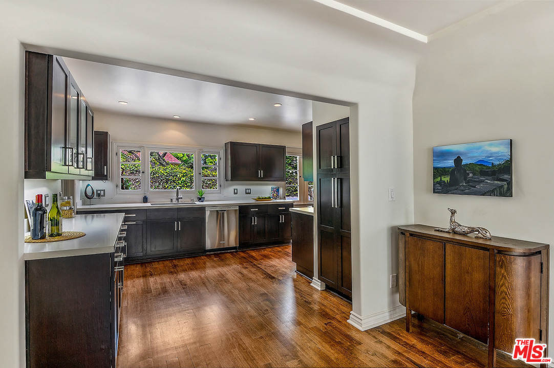 1102 Grant Avenue Venice, CA 90291 - Photo 8 of 29 a kitchen with stainless steel appliances wooden cabinets and a counter top space