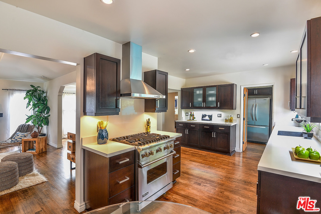 1102 Grant Avenue Venice, CA 90291 - Photo 10 of 29 a kitchen with stainless steel appliances kitchen island granite countertop a stove and a refrigerator