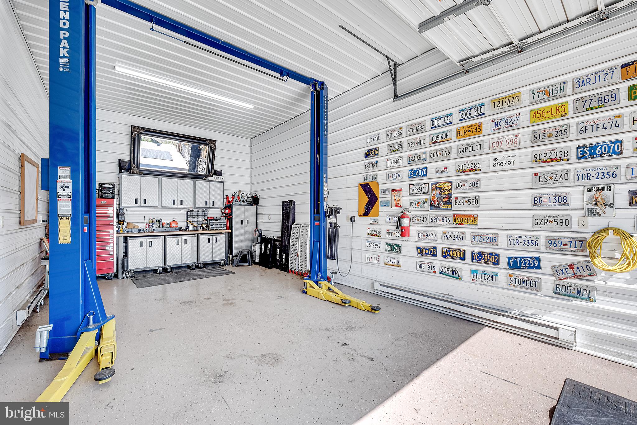 26100 Mullinix Mill Road Mount Airy, MD 21771 - Photo 79 of 99 Spacious garage with vintage license plates.