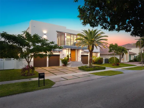 a view of a house with a yard and tree s