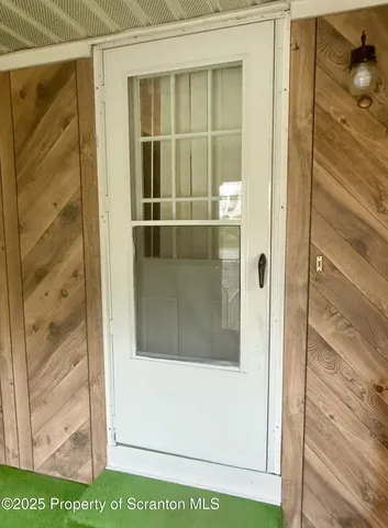 a view of an empty room with window and furniture
