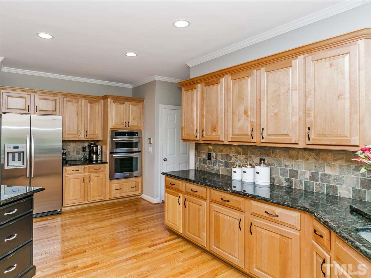 2401 Narrawood Street Raleigh, NC 27614 - Photo 6 of 25 Kitchen Redesigned with New Granite, Cabinet Hardware, Under Cabinet Lighting and Recessed Lighting in Ceiling