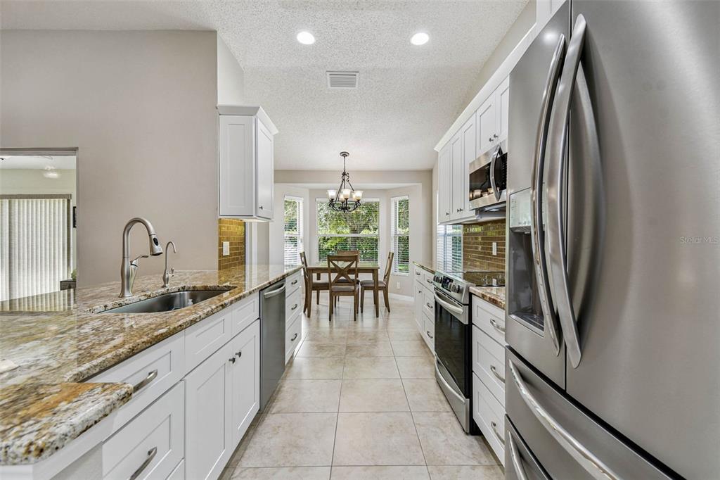 12202 Aaron Terrace Trinity, FL 34655 - Photo 17 of 41 a kitchen with stainless steel appliances granite countertop a refrigerator and a sink