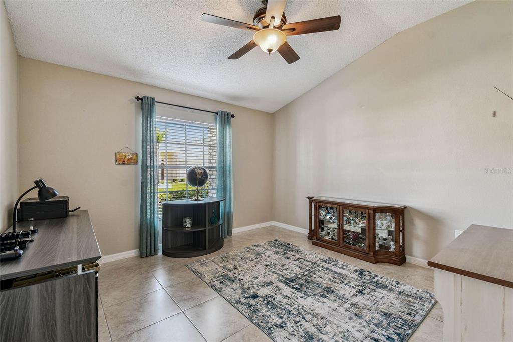 12202 Aaron Terrace Trinity, FL 34655 - Photo 26 of 41 a bedroom with a bed and a dresser