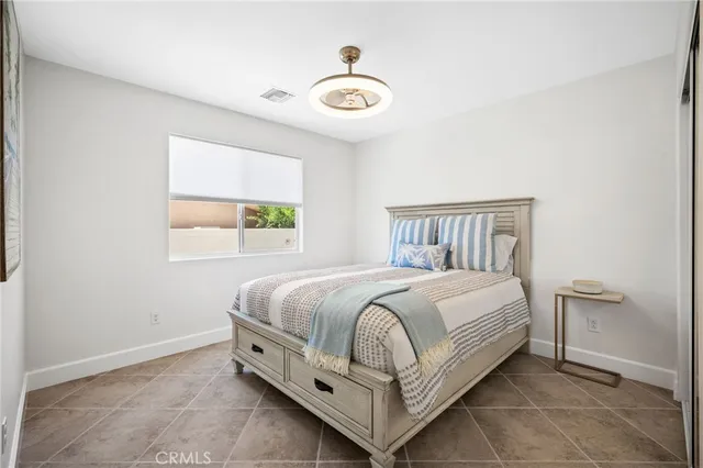 a bed sitting in a bedroom next to a window