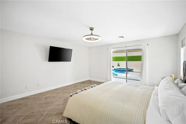 a bedroom with a bed and a television