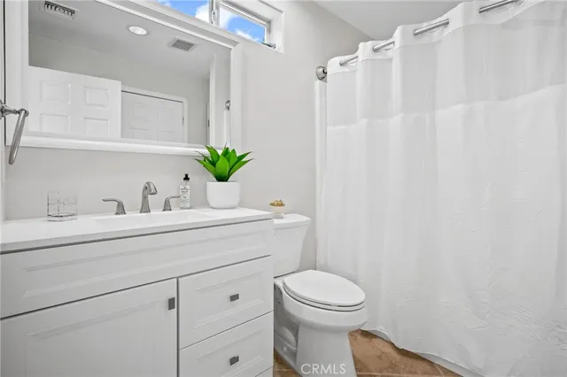 a bathroom with a sink a mirror and a toilet
