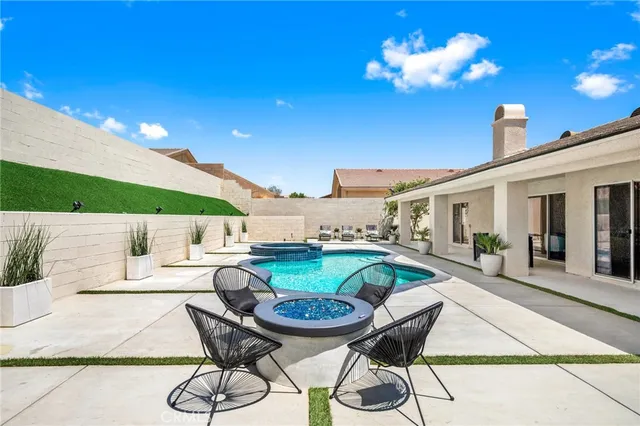 a balcony with table and chairs