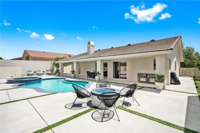 a view of a house with swimming pool and sitting area