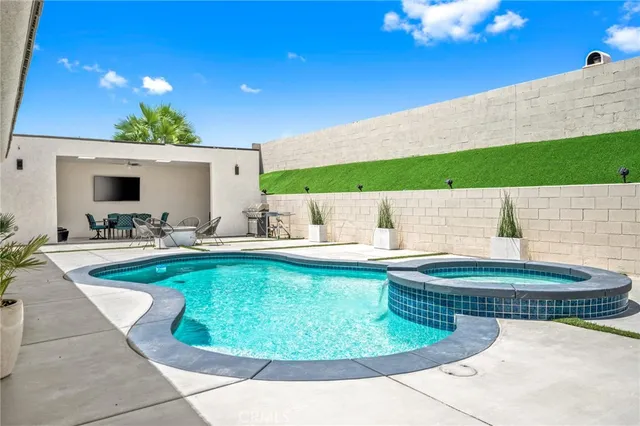 a view of swimming pool with outdoor seating
