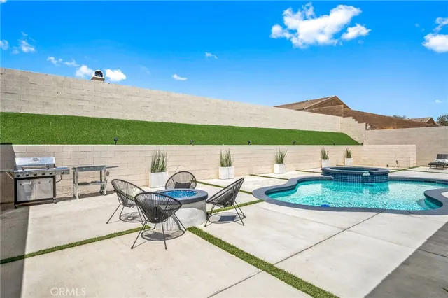 a view of a patio with dining table and chairs