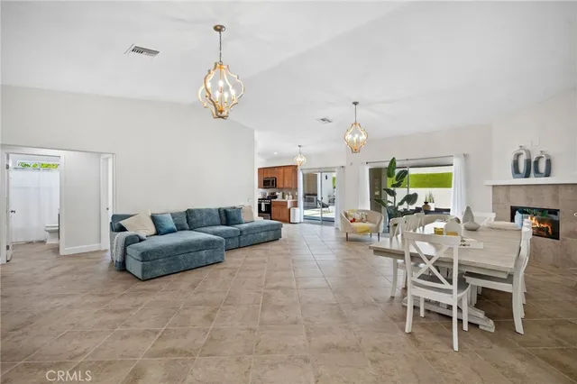 a living room with fireplace furniture and a chandelier