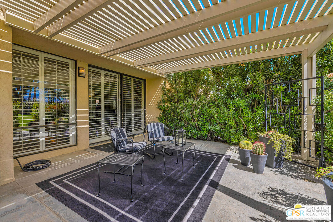 72355 Rodeo Way Rancho Mirage, CA 92270 - Photo 11 of 43 a view of a patio with a table and chairs and floor to ceiling window