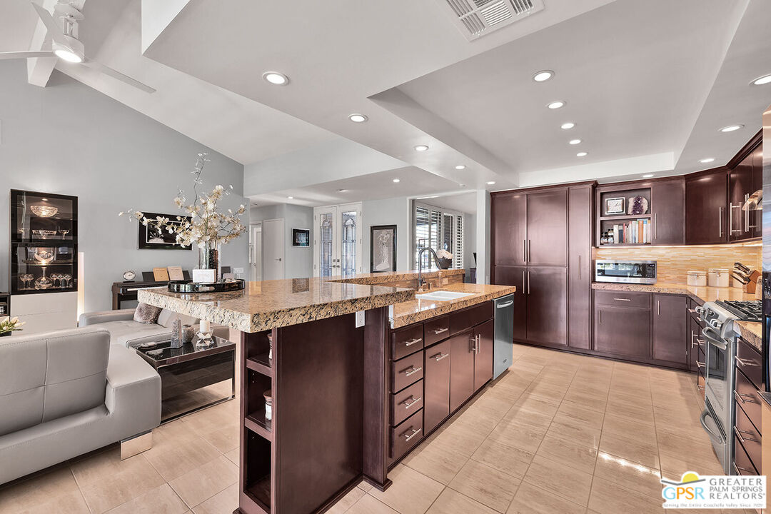 72355 Rodeo Way Rancho Mirage, CA 92270 - Photo 14 of 43 a large kitchen with stainless steel appliances lots of counter space and living room