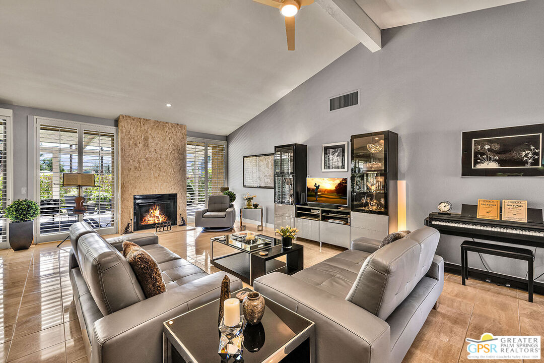 72355 Rodeo Way Rancho Mirage, CA 92270 - Photo 2 of 43 a living room with furniture a fireplace and a flat screen tv