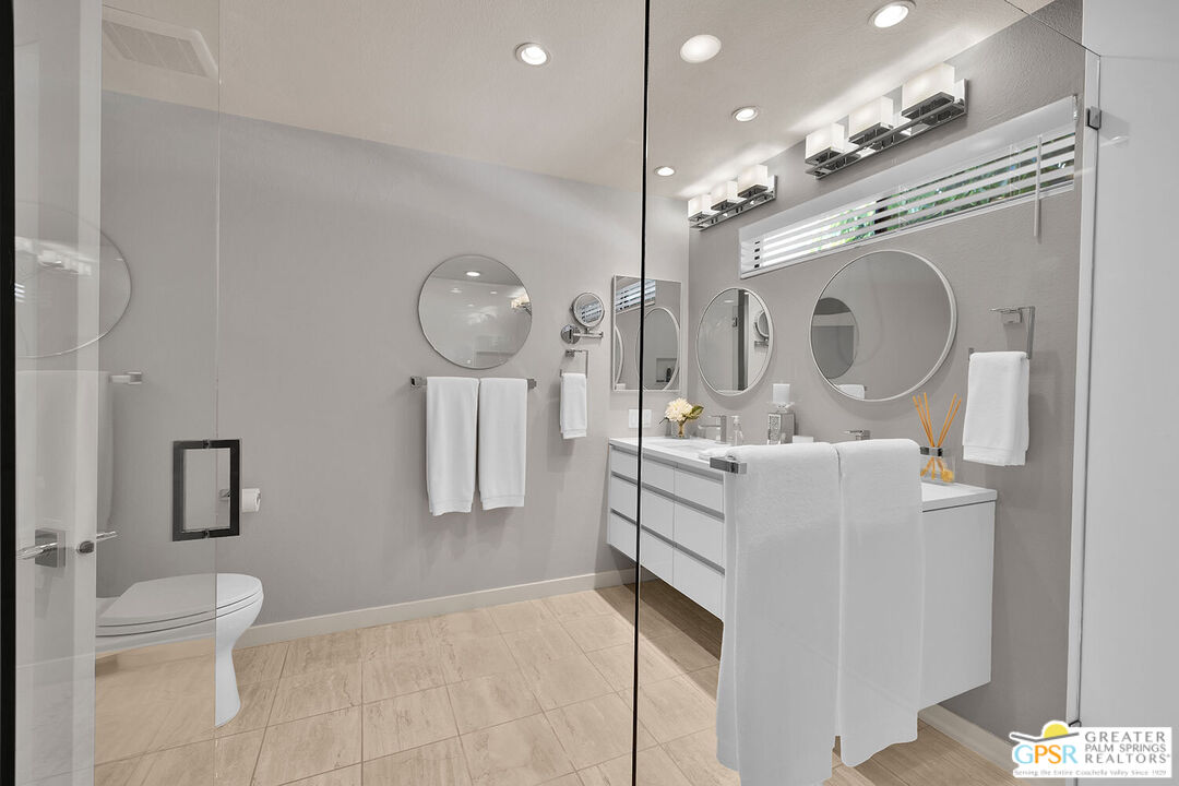 72355 Rodeo Way Rancho Mirage, CA 92270 - Photo 23 of 43 a bathroom with a sink vanity mirror and toilet