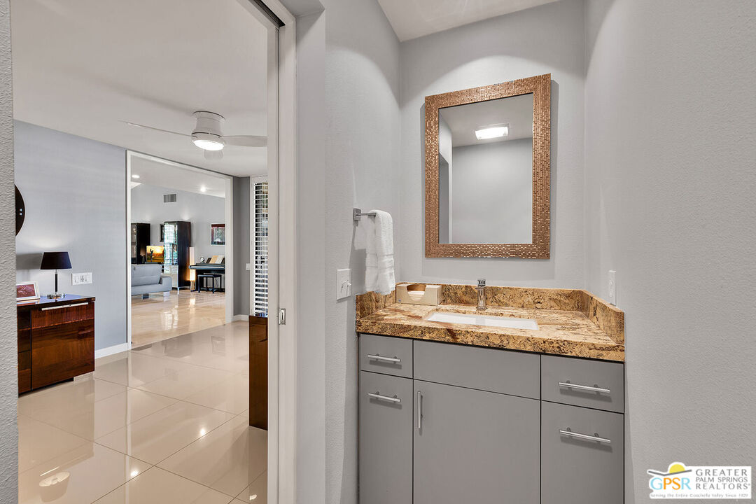 72355 Rodeo Way Rancho Mirage, CA 92270 - Photo 31 of 43 a en suite bathroom with a sink and a mirror