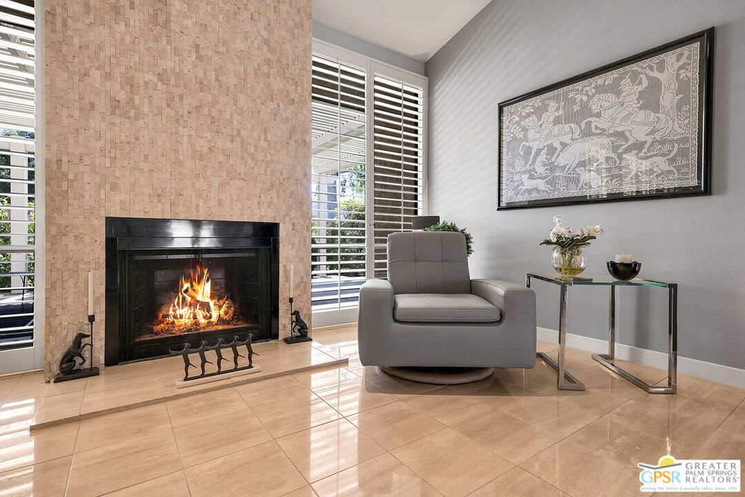 72355 Rodeo Way Rancho Mirage, CA 92270 - Photo 7 of 43 a living room with furniture a fireplace and a flat screen tv