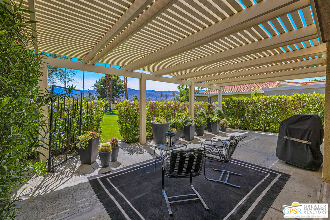 72355 Rodeo Way Rancho Mirage, CA 92270 - Photo 10 of 43 a view of a patio with table and chairs potted plants with wooden floor and seating space
