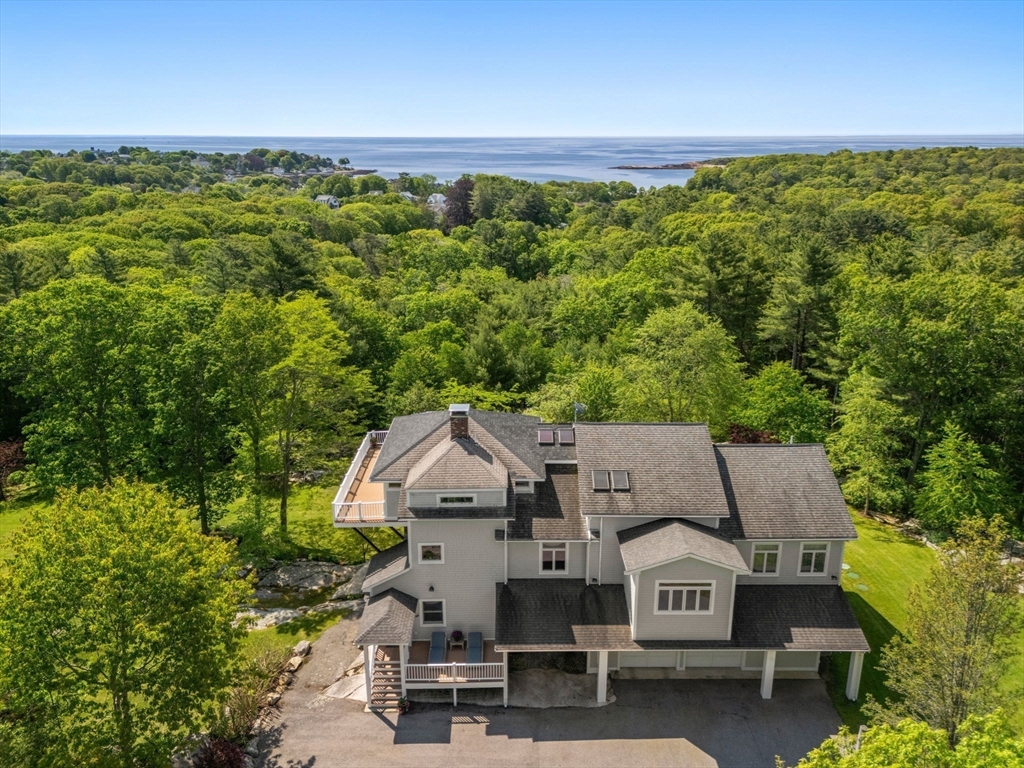 602 Summer Street Manchester, MA 01944 - Photo 2 of 34 an aerial view of a house with a yard and lake view