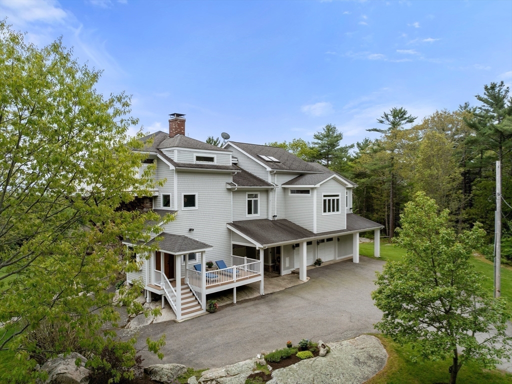 602 Summer Street Manchester, MA 01944 - Photo 30 of 34 aerial view of a house with a yard and balcony