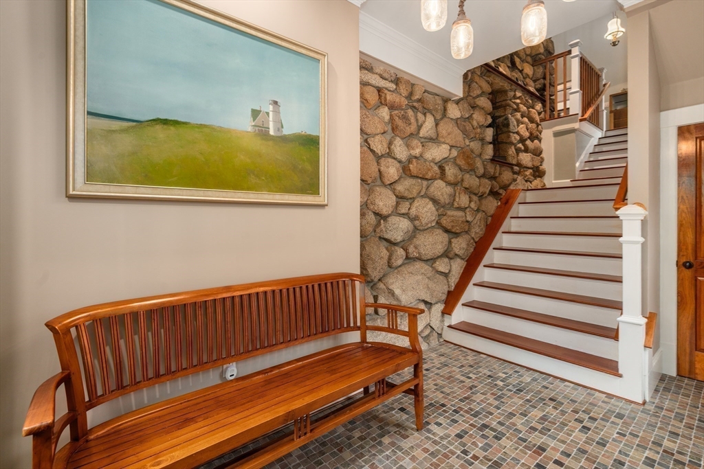 602 Summer Street Manchester, MA 01944 - Photo 8 of 34 a view of wooden staircase with rug and a window