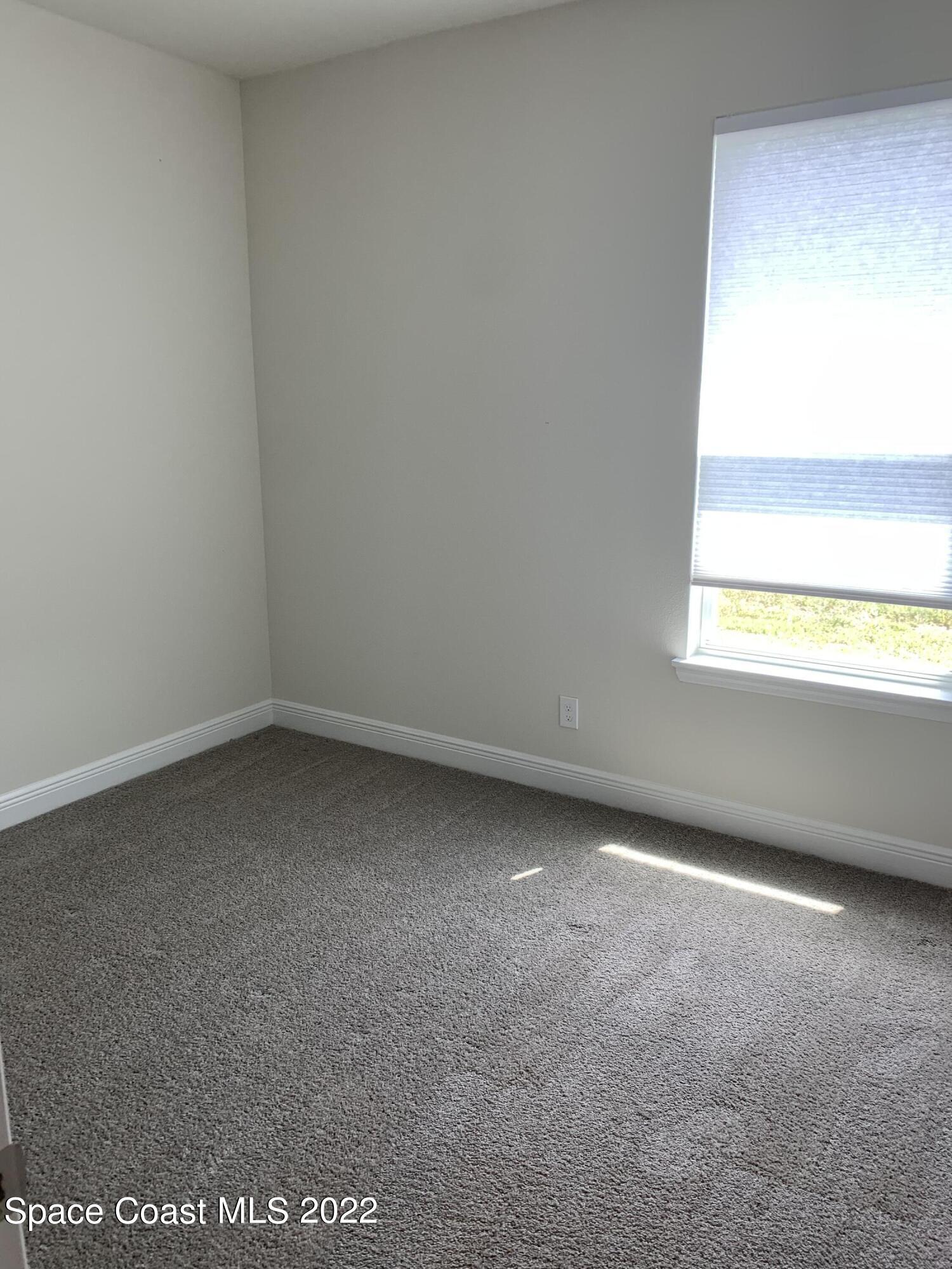 1893 Killian Drive Palm Bay, FL 32905 - Photo 15 of 25 an empty room with a window