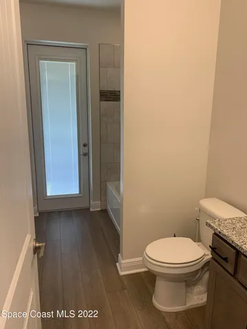 a bathroom with a shower and toilet