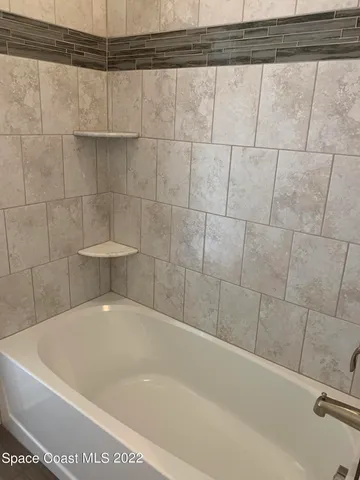 a bathroom with a granite countertop toilet and a sink
