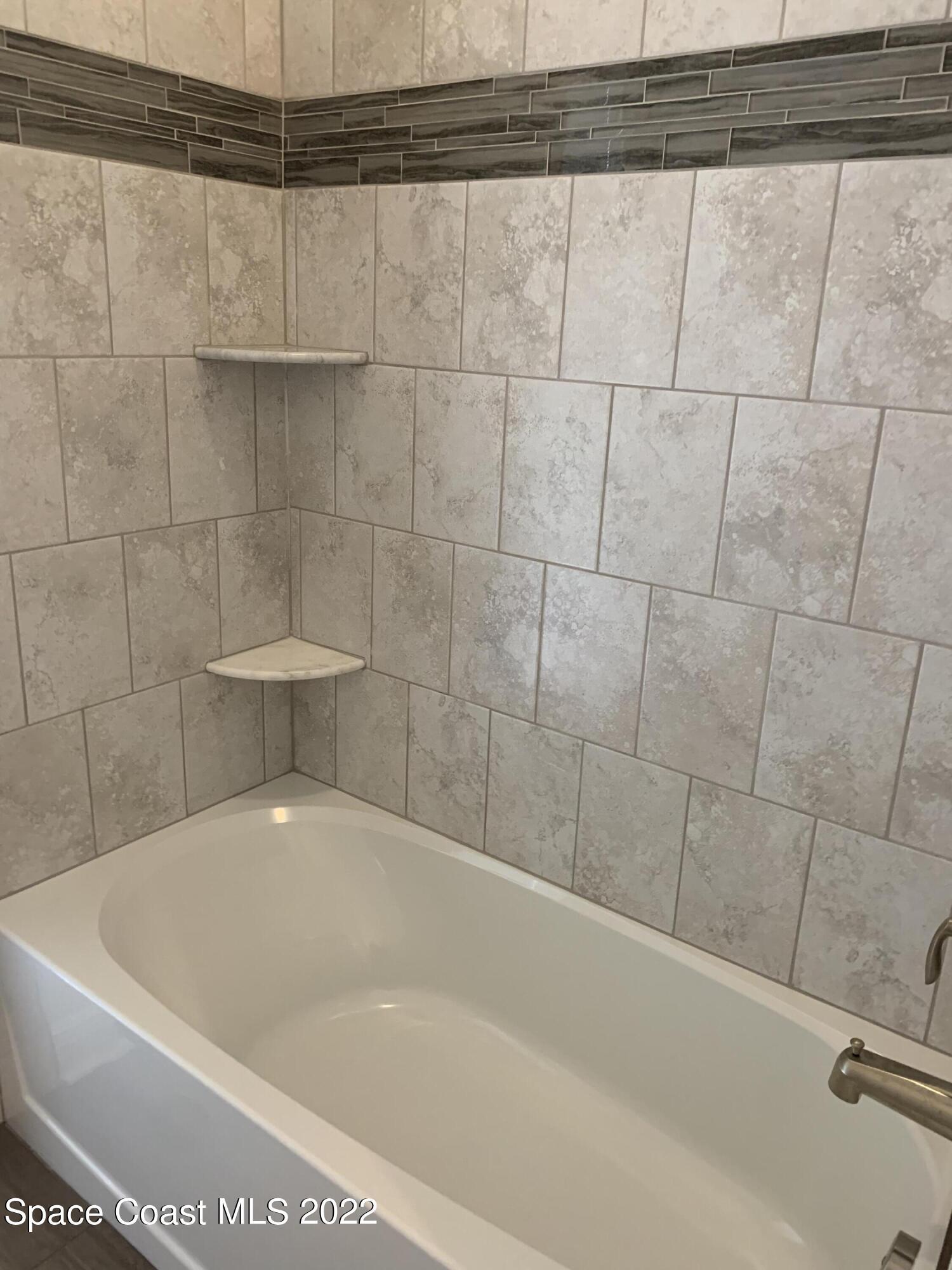 1893 Killian Drive Palm Bay, FL 32905 - Photo 18 of 25 a bathroom with a bathtub